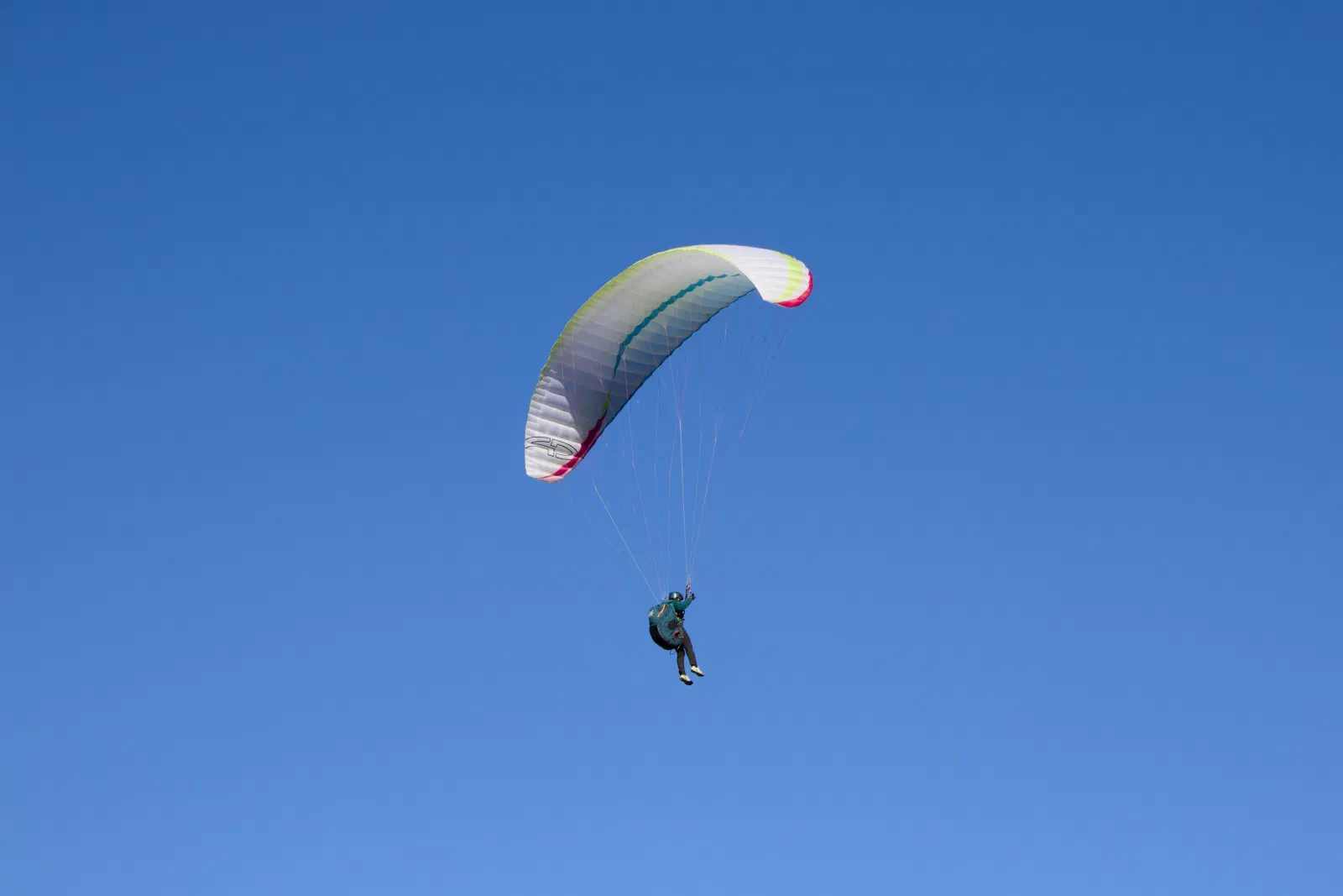 Paraglider against a blue sky