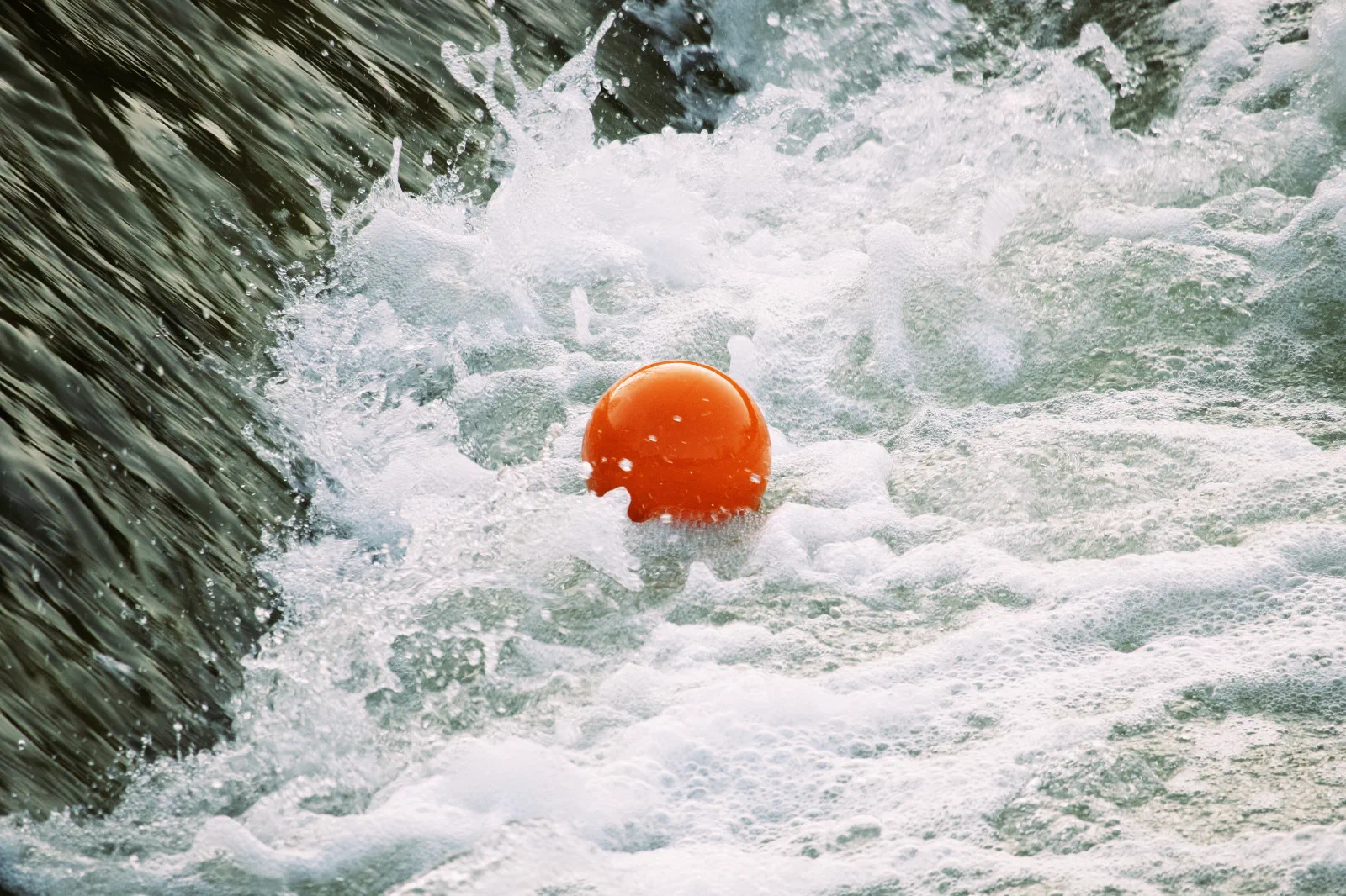 Orange ball trapped in the weir eddy