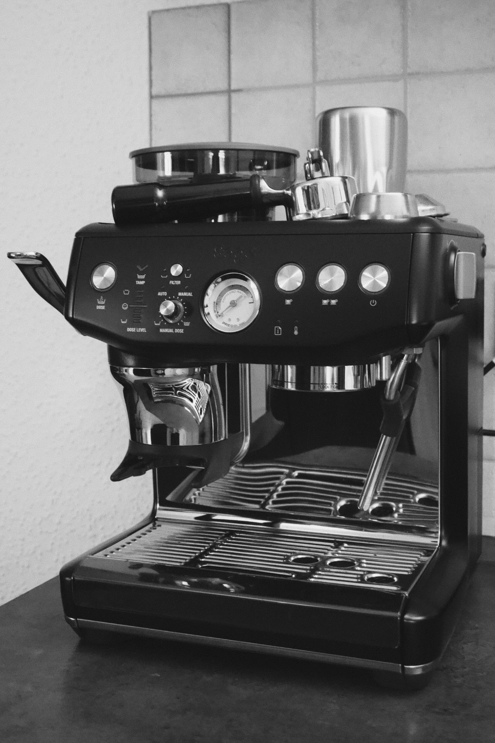 Black and white photo of a black espresso machine