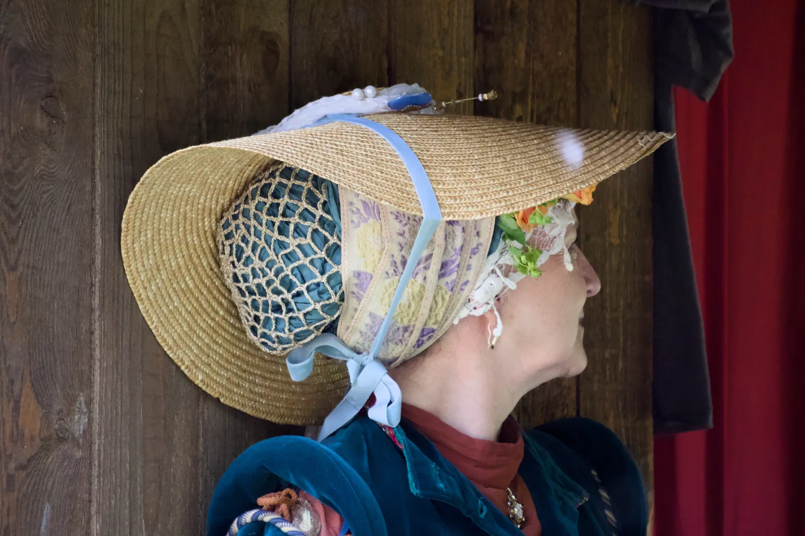 A woman in an elaborate straw bonnet
