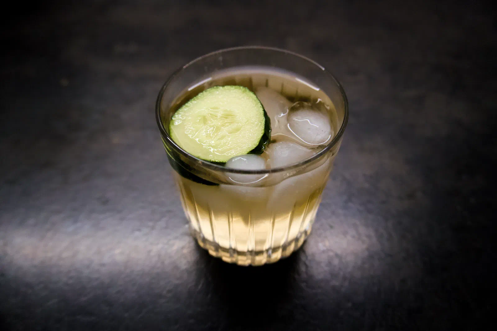 A virgin lemon gin and tonic with cucumber and ice in a glass