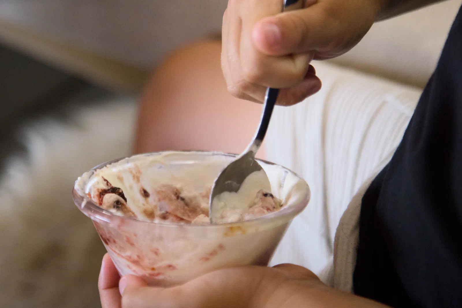 Bowl of ice cream in a kid's hands