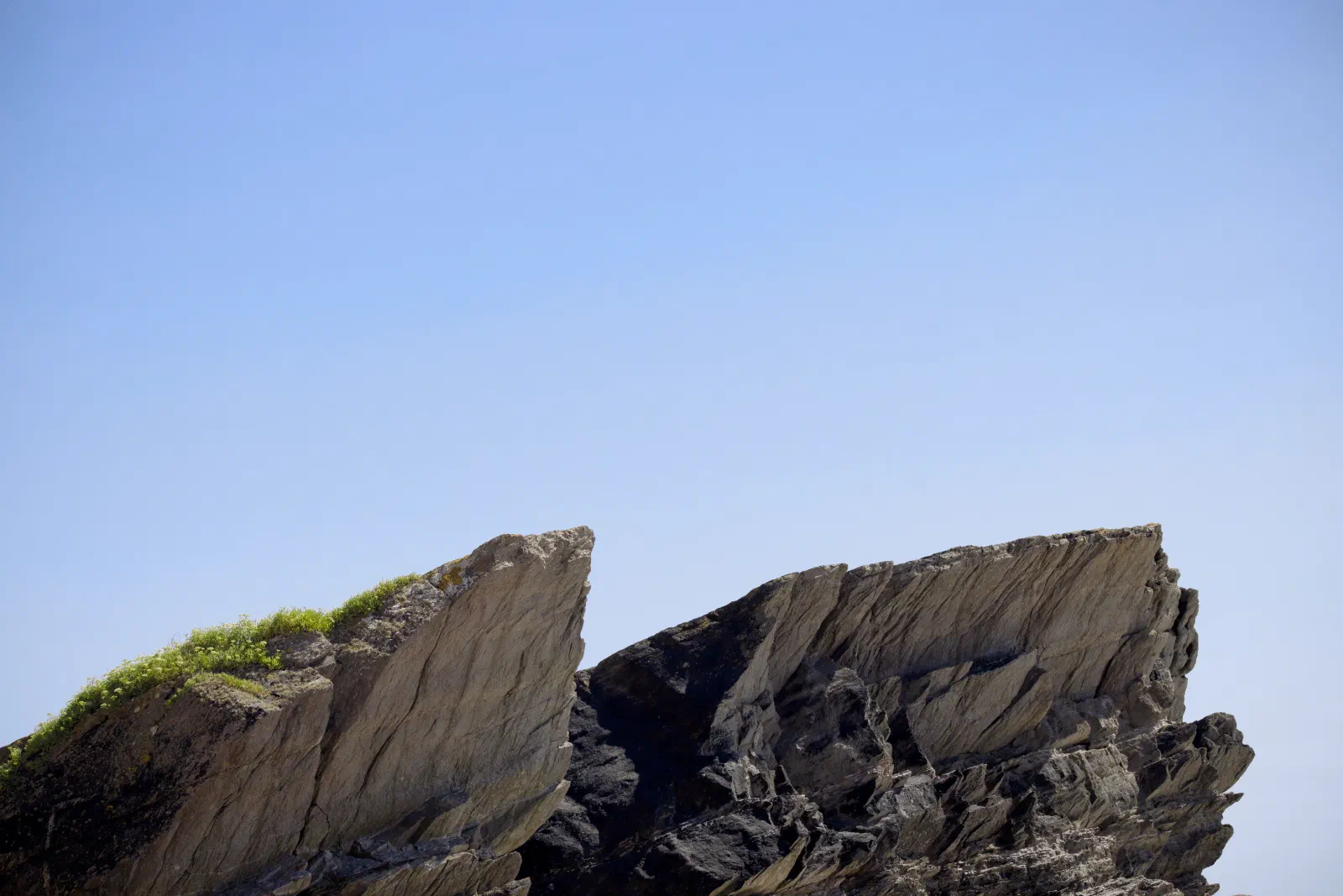 Angular rock slabs against the blue sky