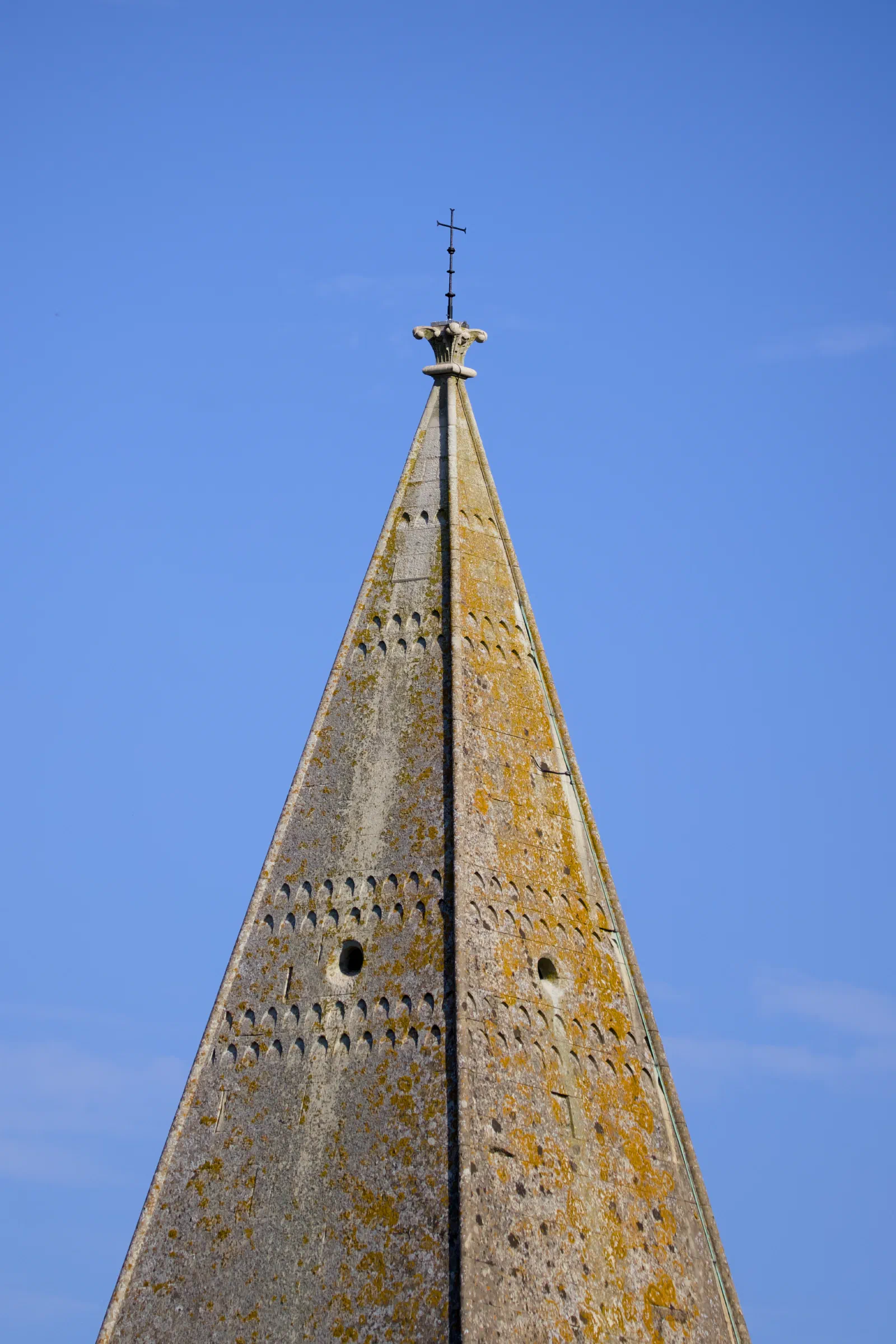 Spire of St John the Baptist against a blue sky