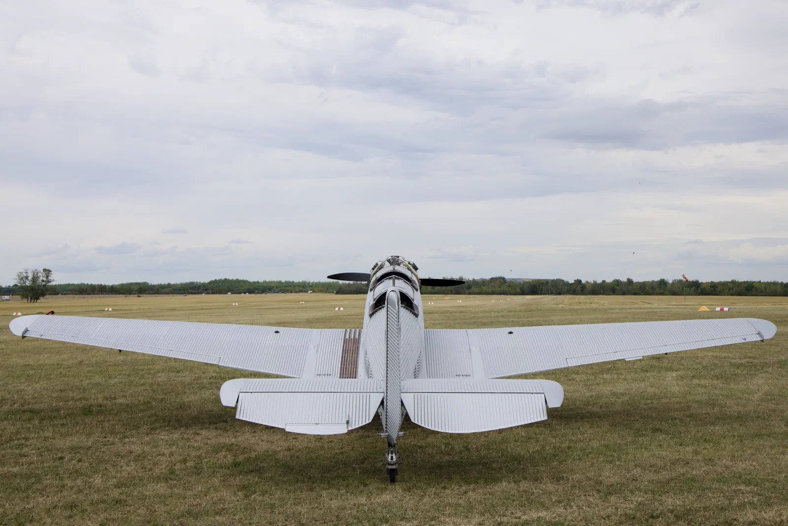 Junkers A50 Junior from behind on a grass airfield