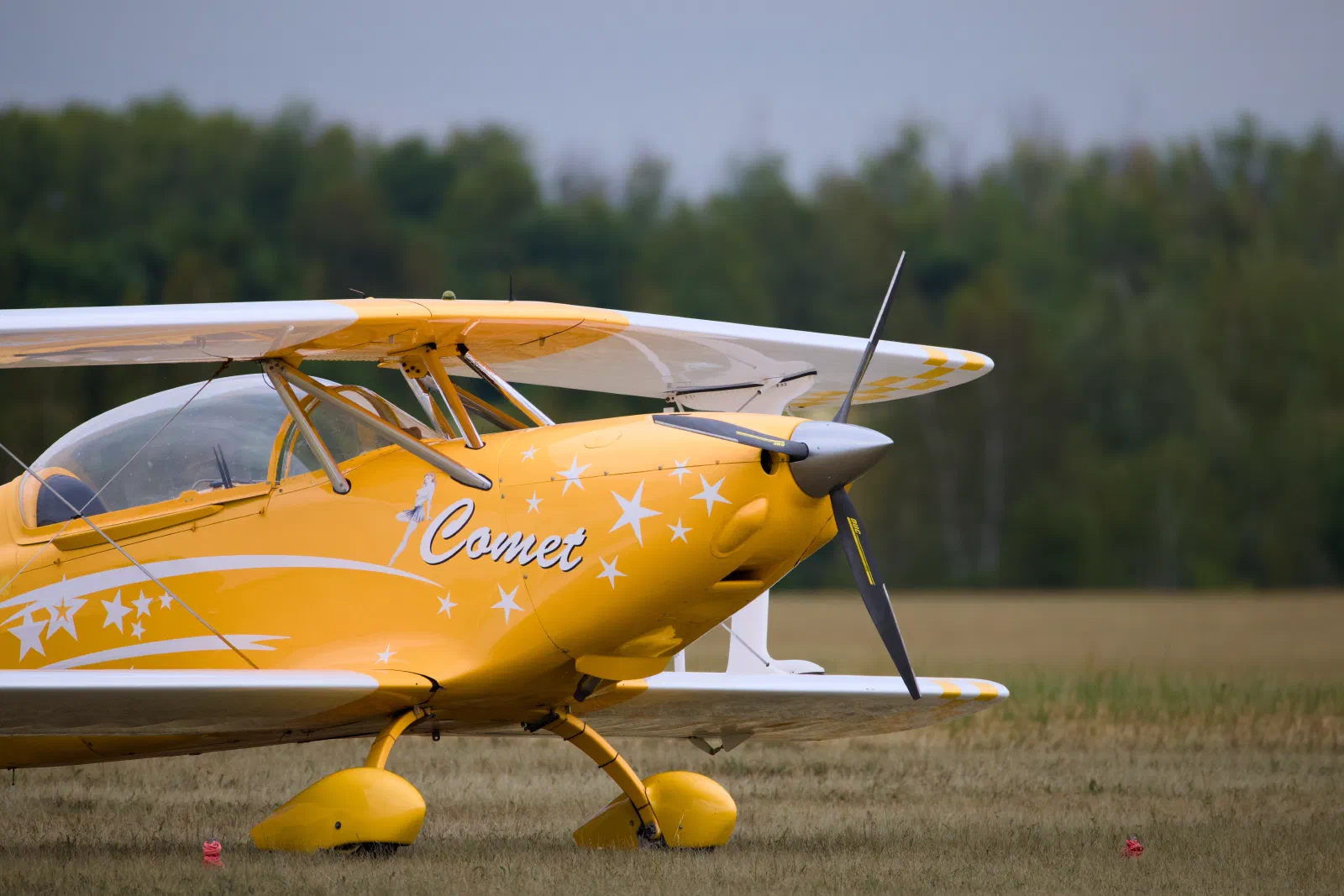 Yellow aerobatic biplane named Comet
