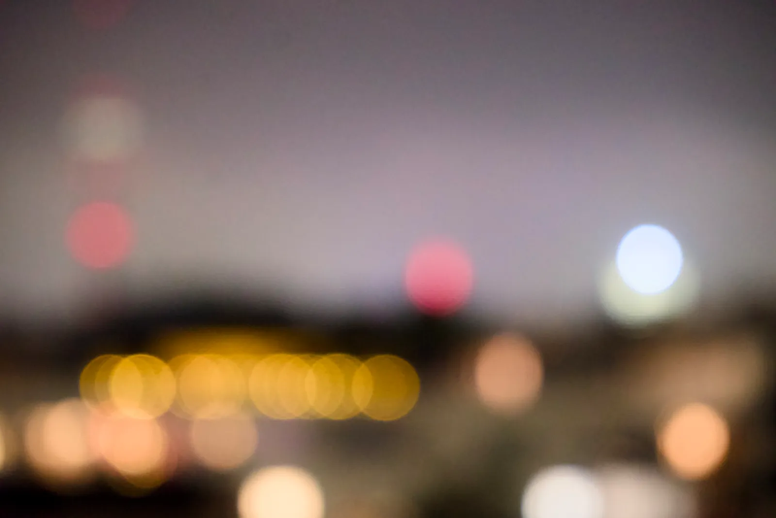 Out-of-focus Olympic Tower and city lights at night