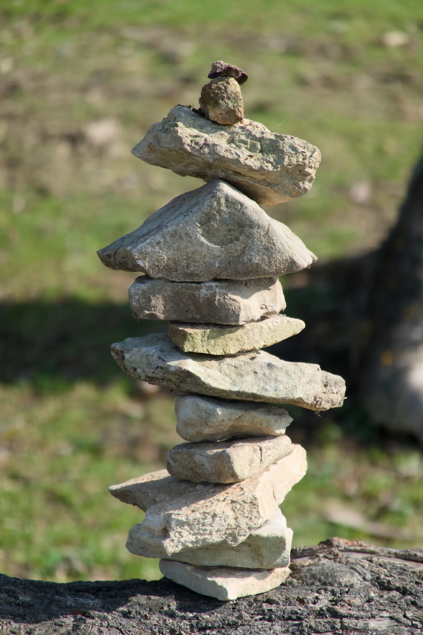 Stone tower on a dead tree stump
