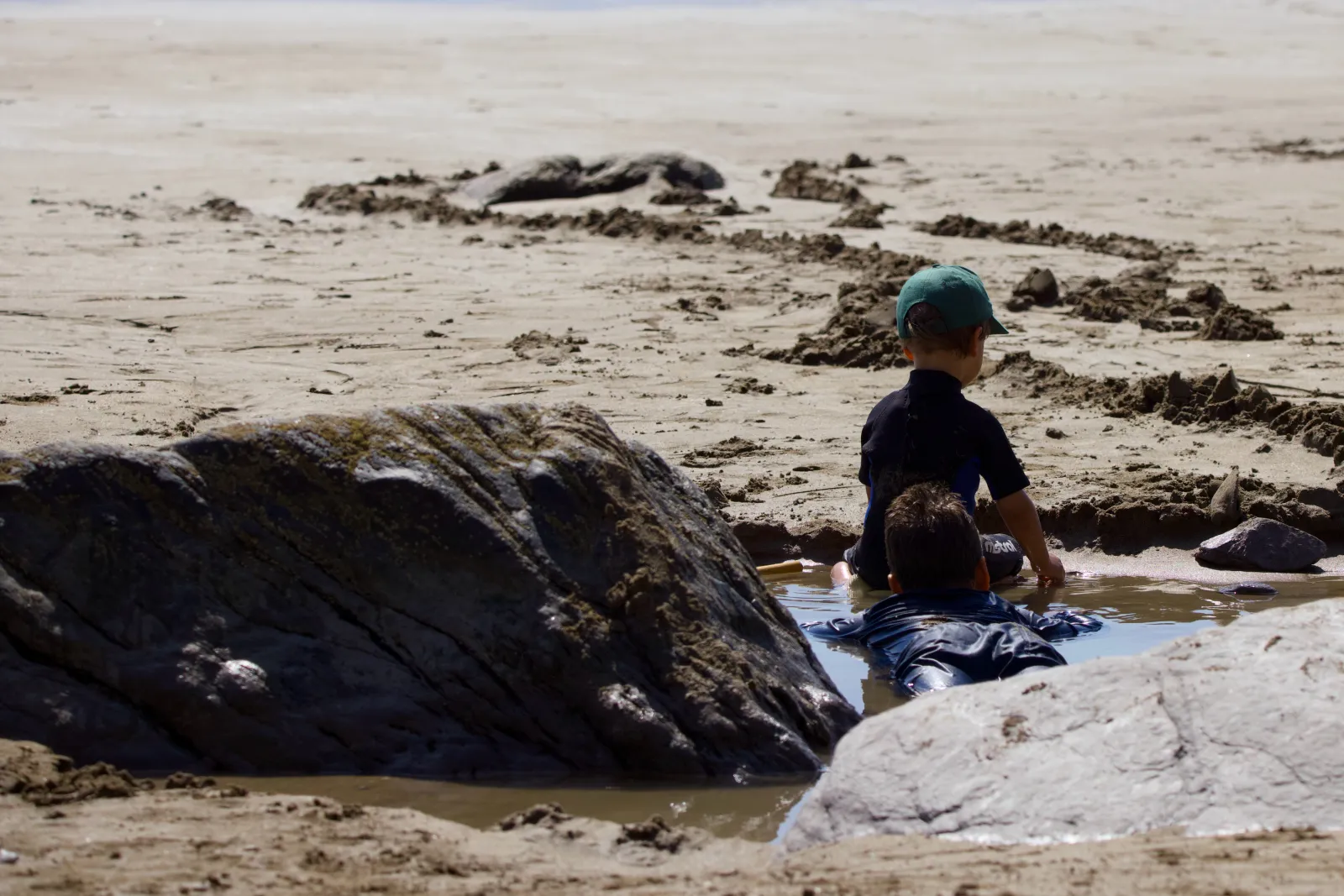 The boys playing in a tide pool between the rocks