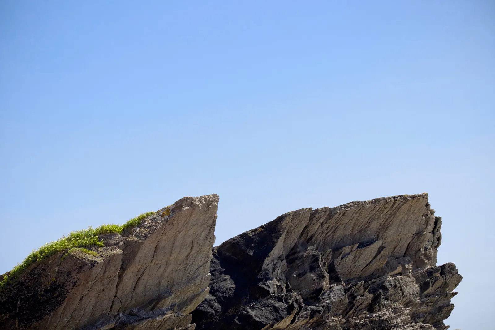 Angular rock slabs against the blue sky