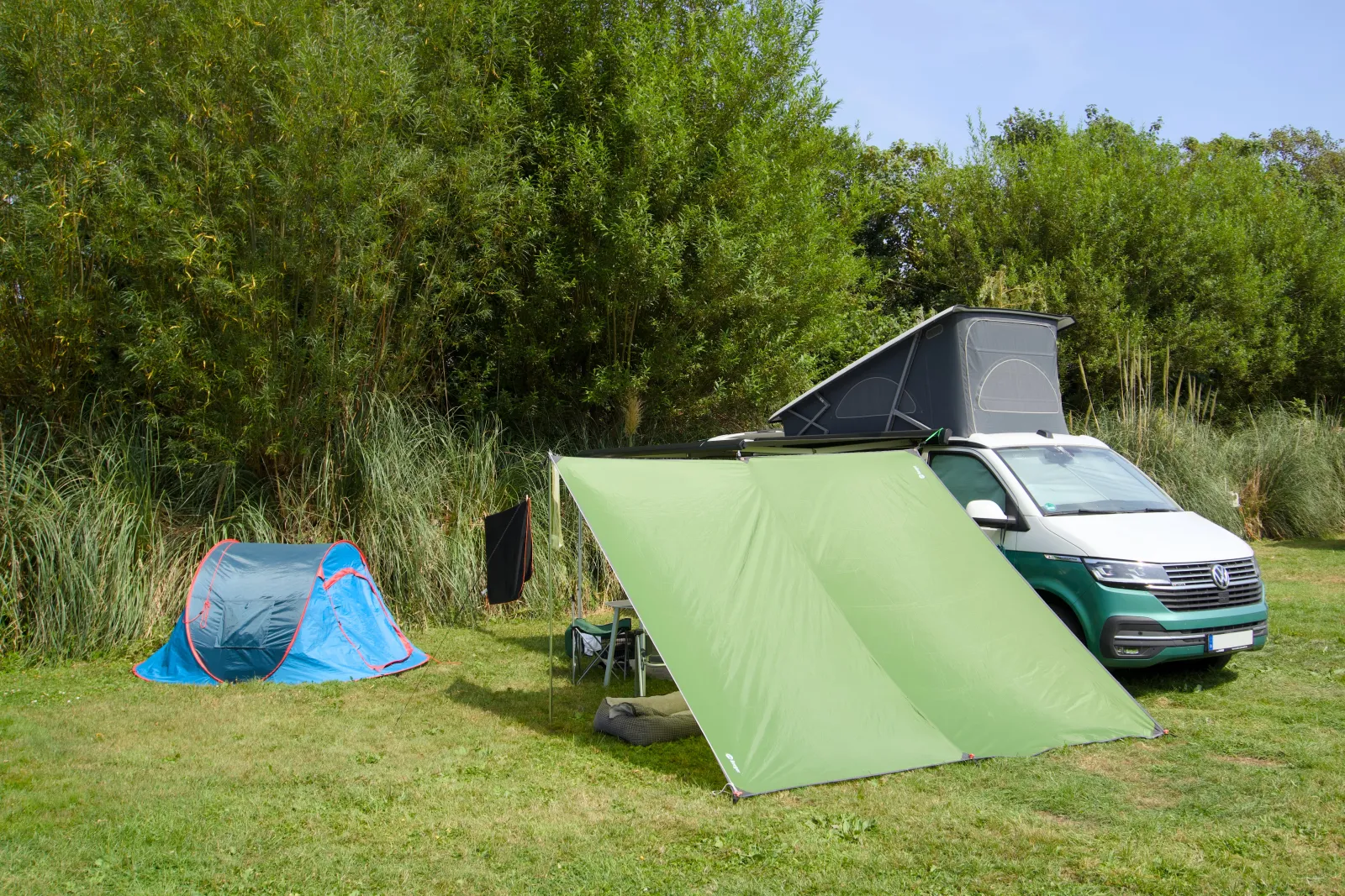 The California with the green awning tent and the blue pop-up tent on the pitch