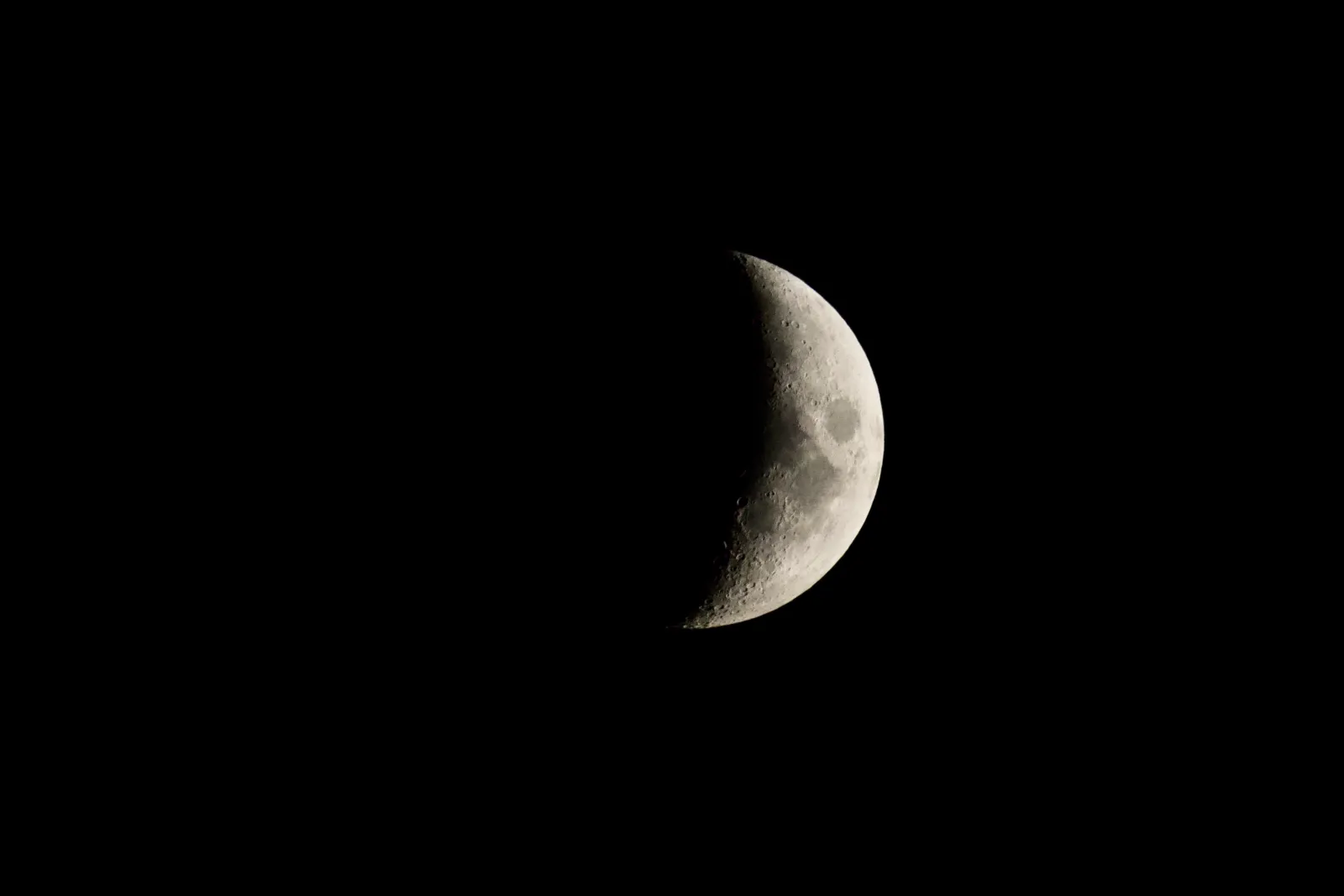 Waxing crescent moon against the black night sky
