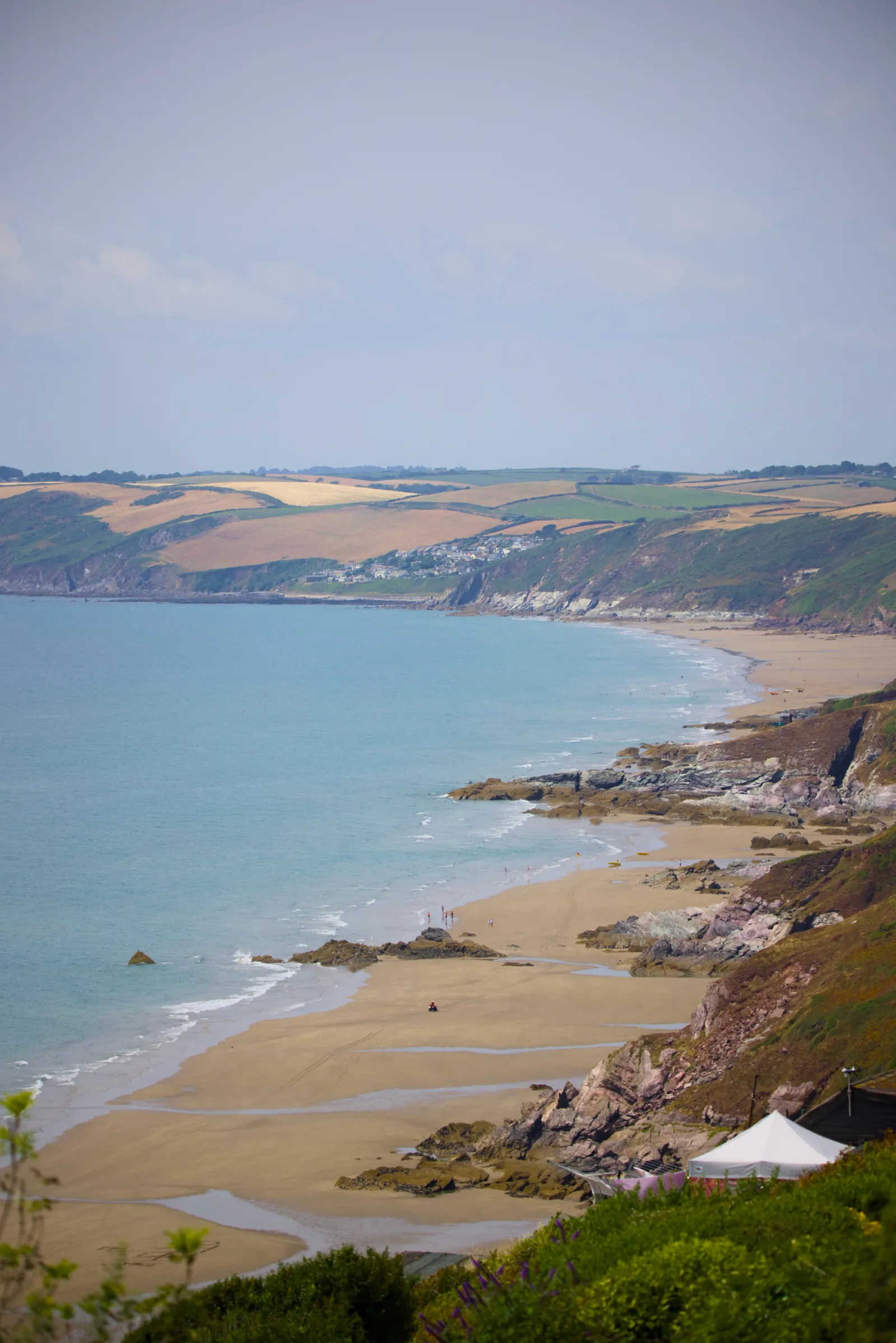 Long sandy beach of Whitsand Bay below the cliffs