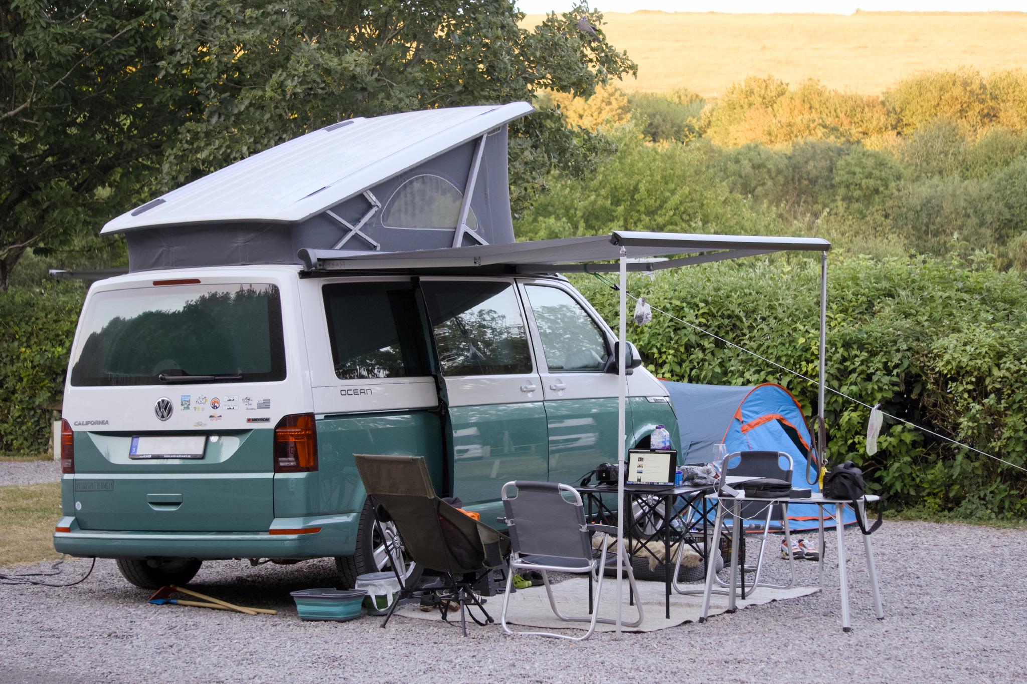 California with the roof up and the awning out at the pitch, evening light