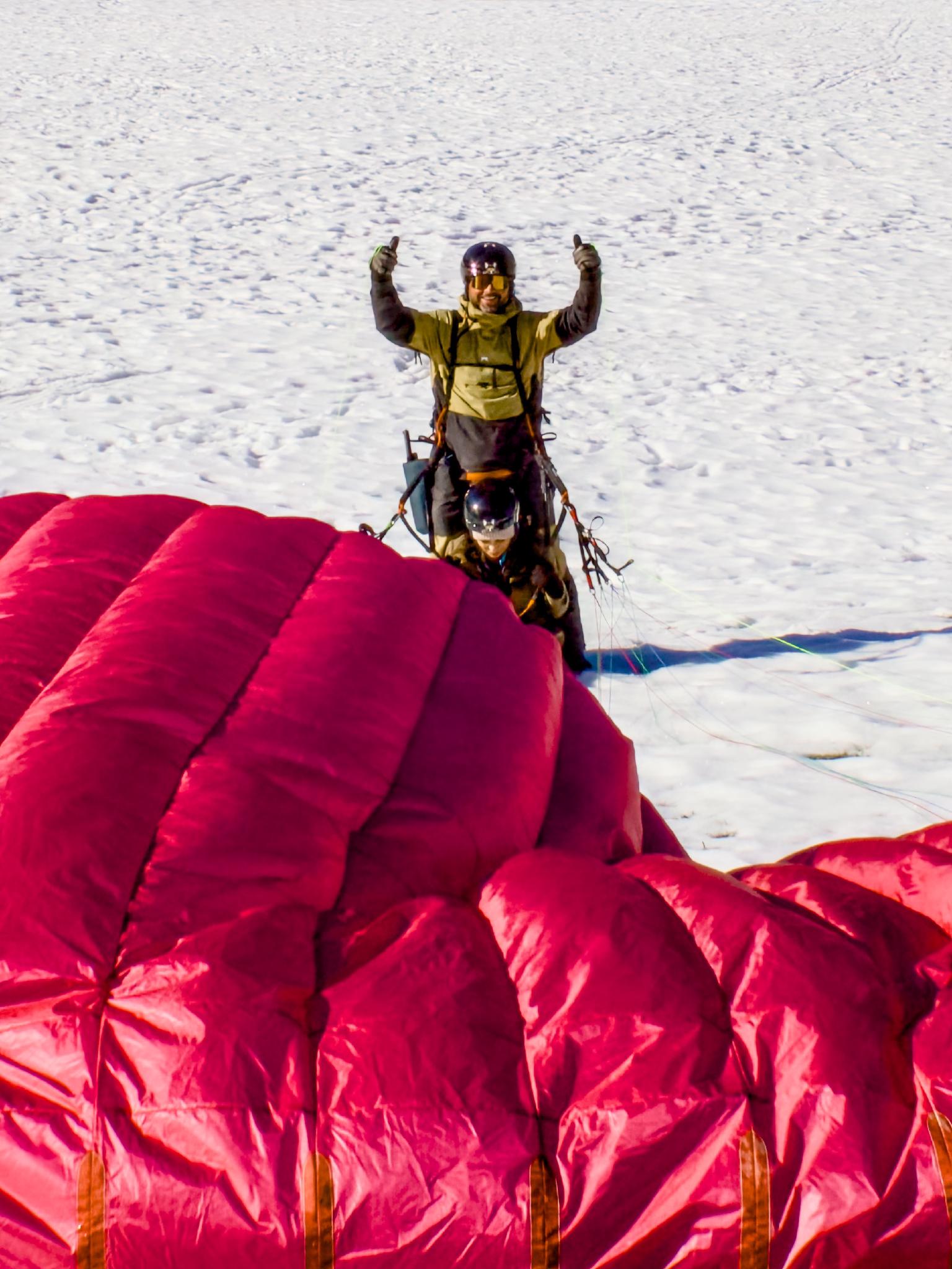 Tandem paraglider coming in to land