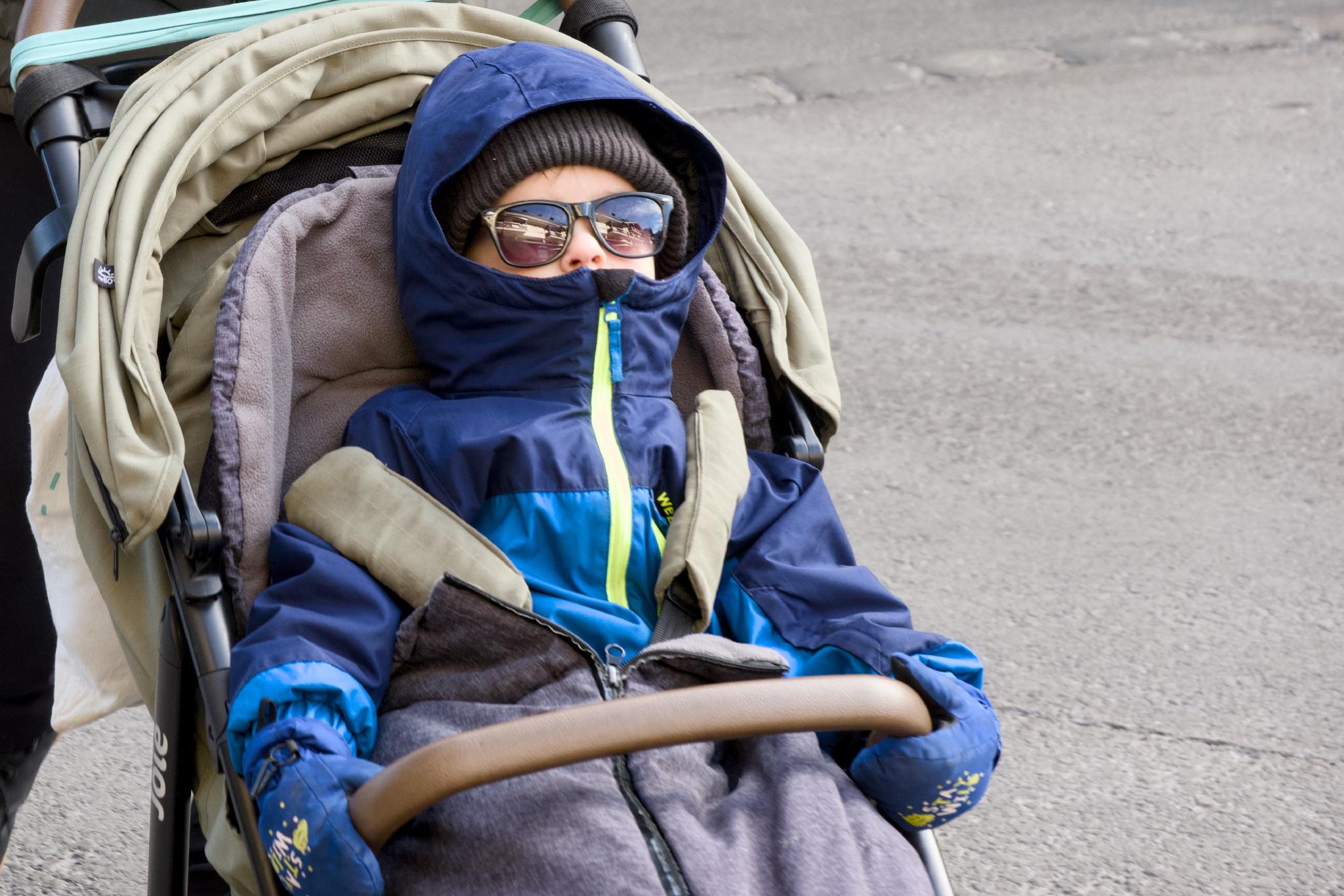 Kellin in the stroller wearing sunglasses