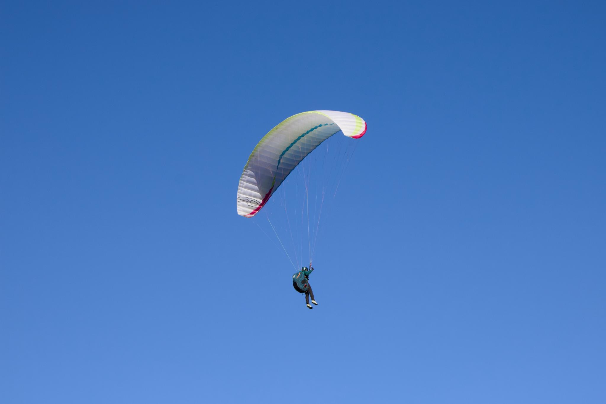Paraglider against a blue sky
