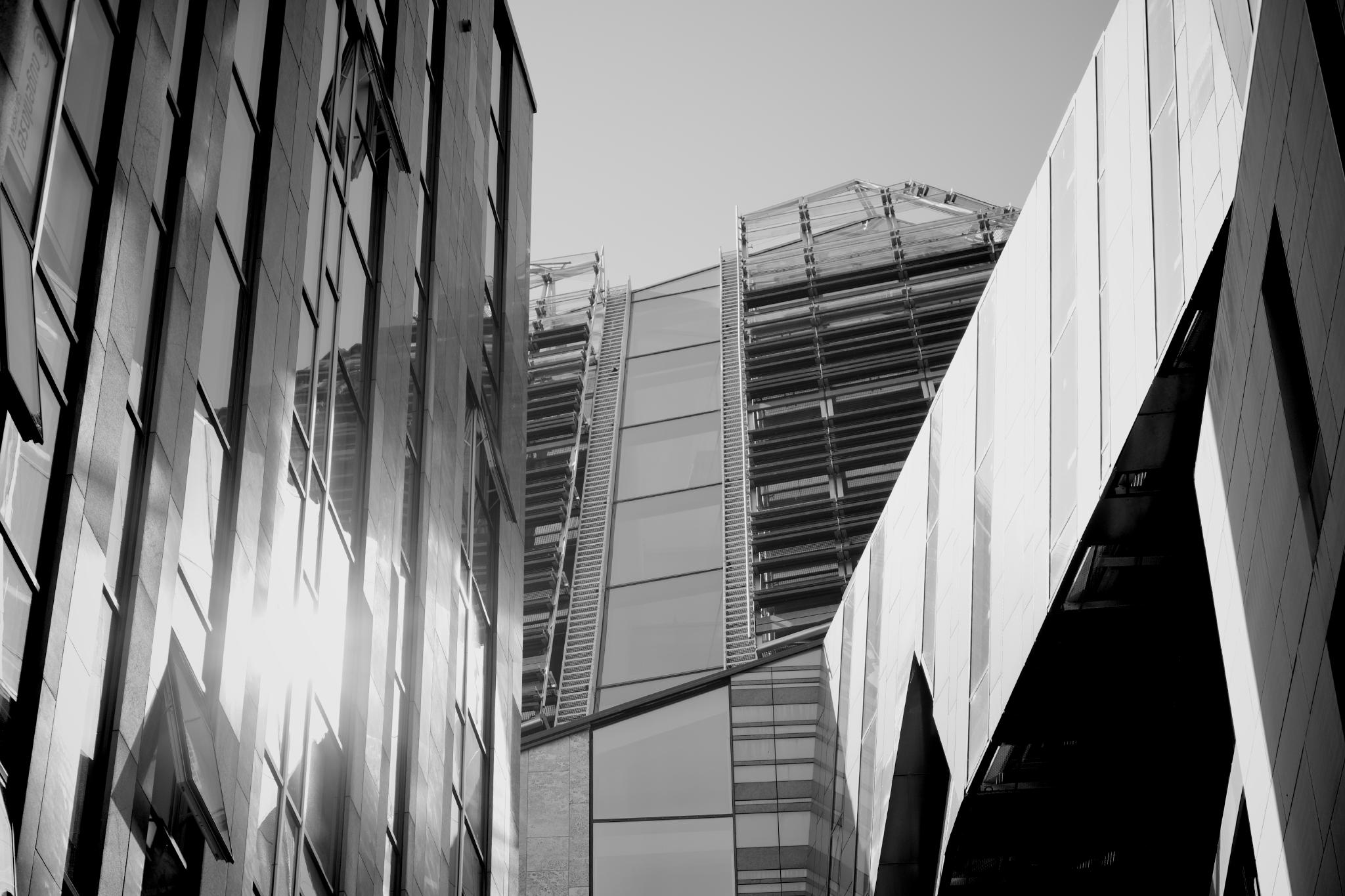 Black and white photo of modern glass facades with external stairs