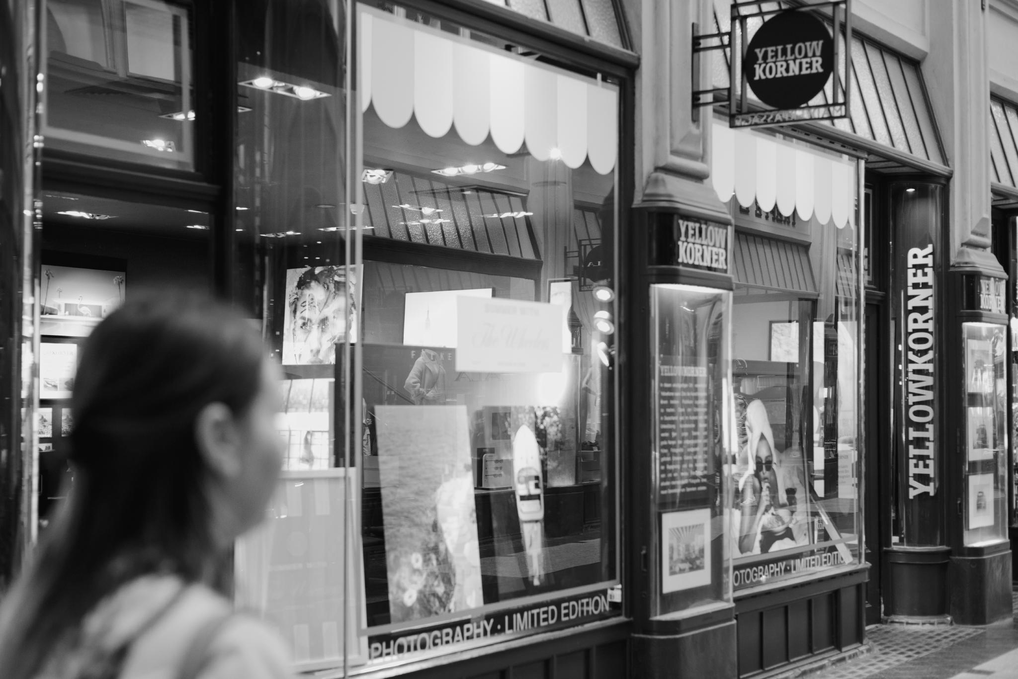 Black and white photo of a photo gallery storefront in an arcade