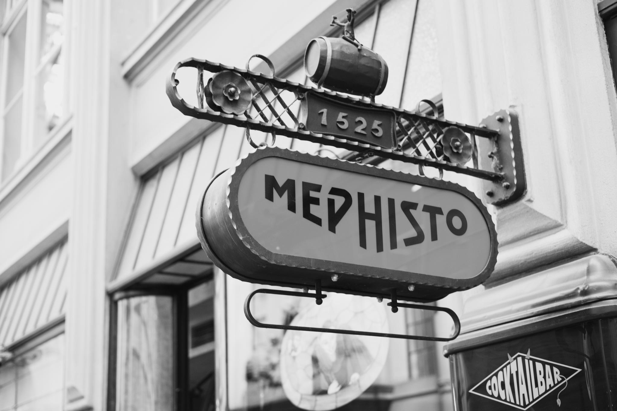 Black and white photo of the Mephisto sign at a cocktail bar