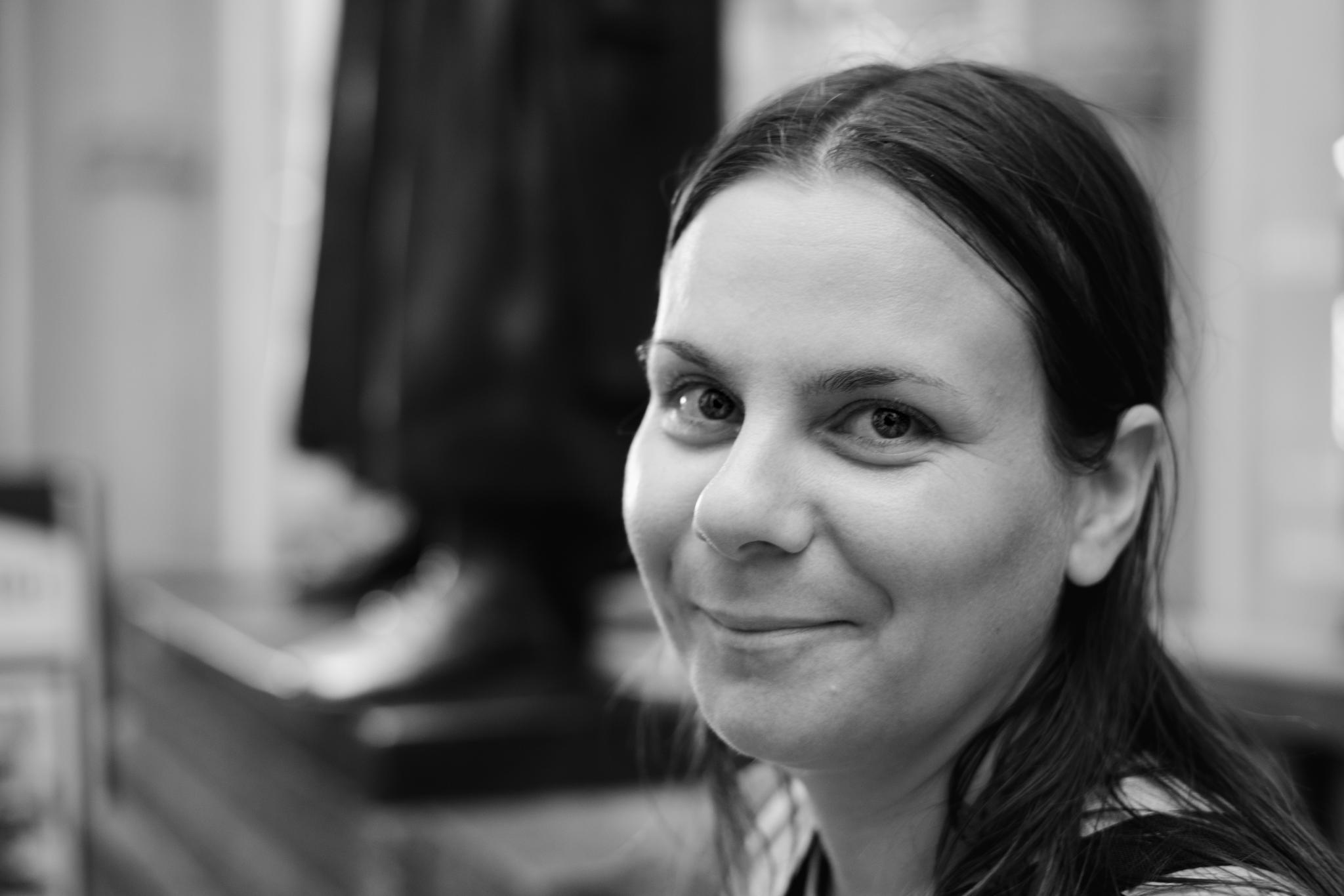 Black and white portrait of Nadine smiling