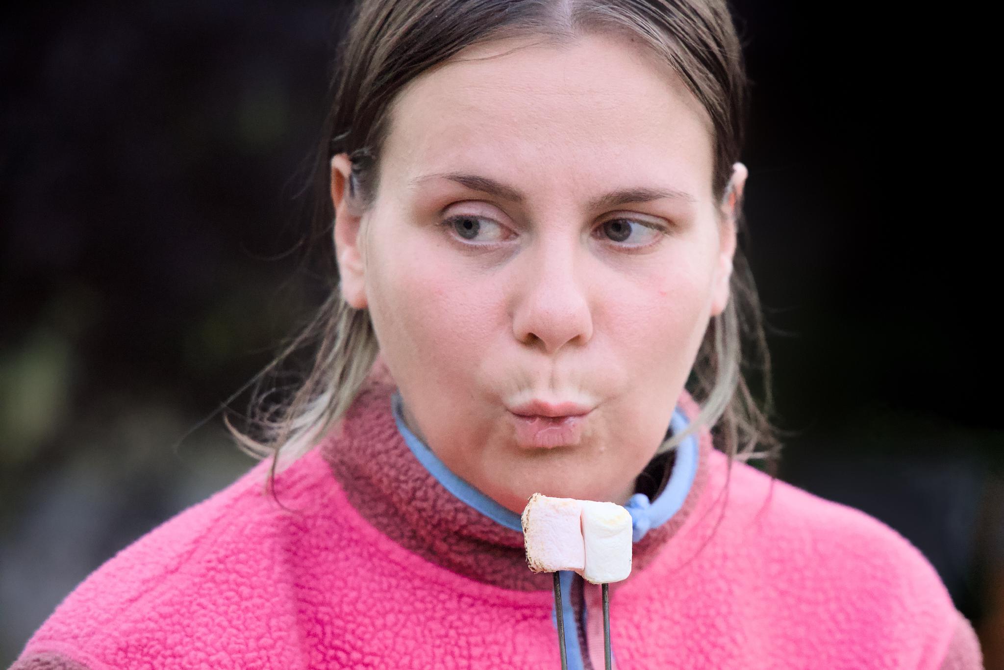 Nadine blowing on roasted marshmallows