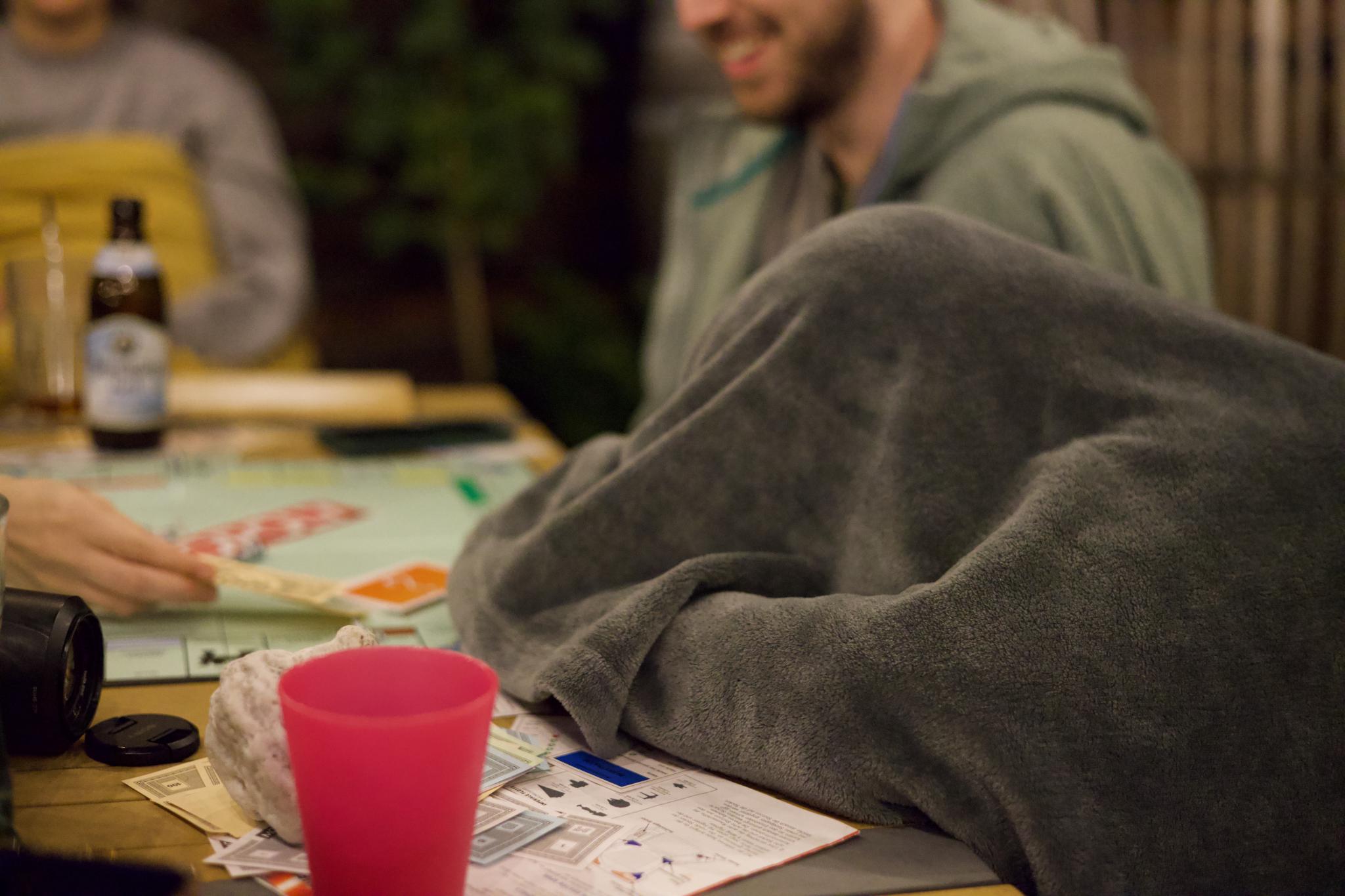 Tilian under a gray blanket at the games table