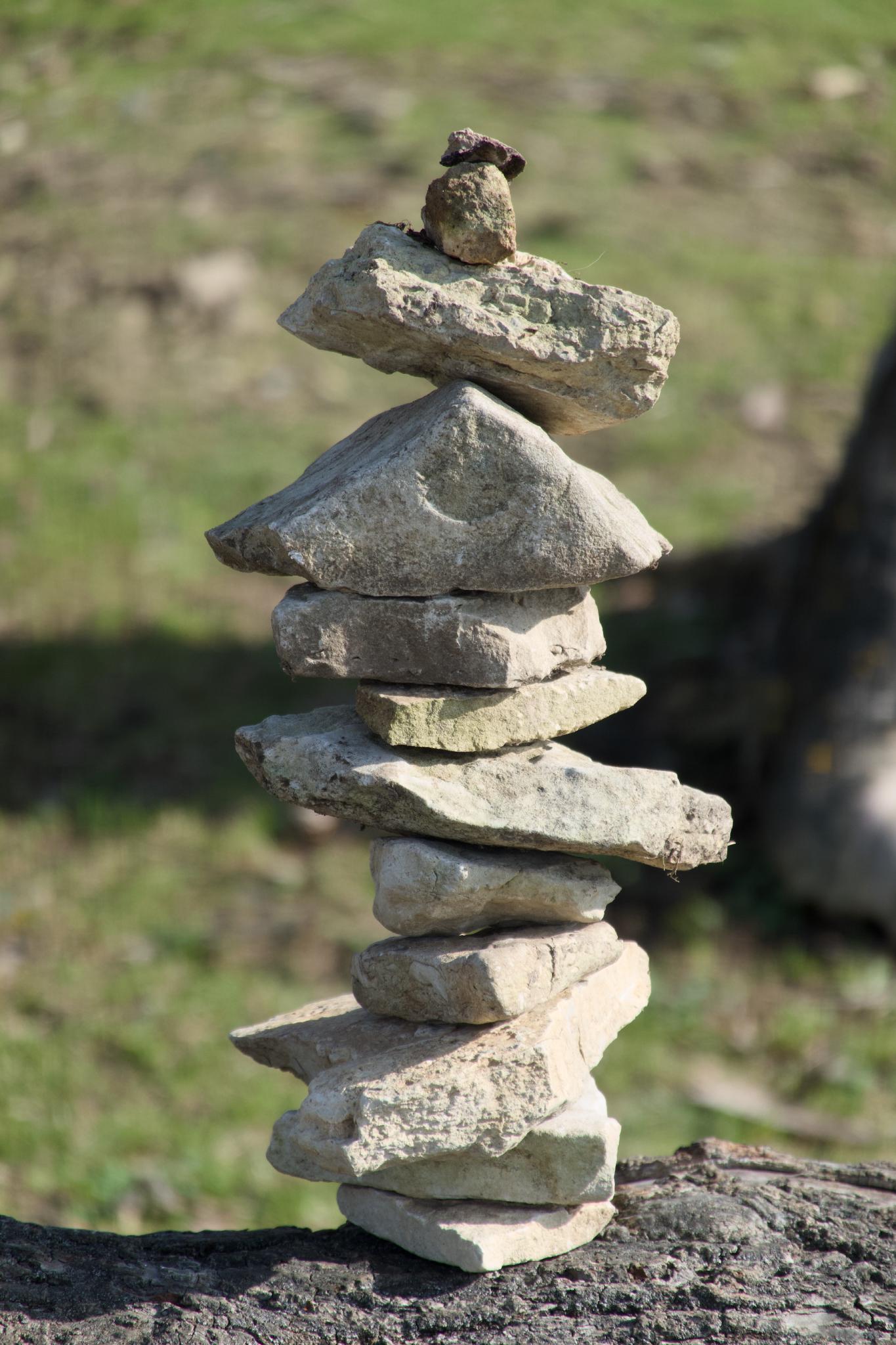 Stone tower on a dead tree stump